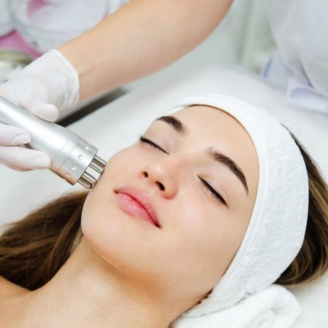 Woman at medical spa getting aesthetic treatments to her face